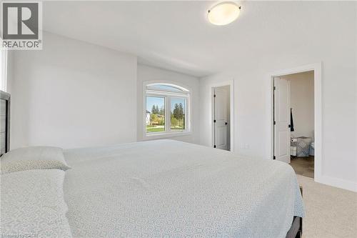 Bedroom with light carpet and baseboards - 7266 Silver Creek Circle, London, ON - Indoor Photo Showing Bedroom