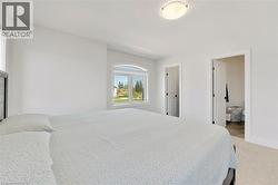 Bedroom with light carpet and baseboards - 