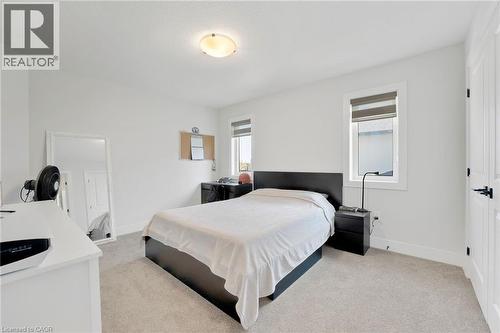 Bedroom with light colored carpet and baseboards - 7266 Silver Creek Circle, London, ON - Indoor Photo Showing Bedroom