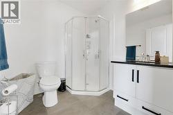 Full bathroom with a stall shower, vanity, and light tile patterned flooring - 