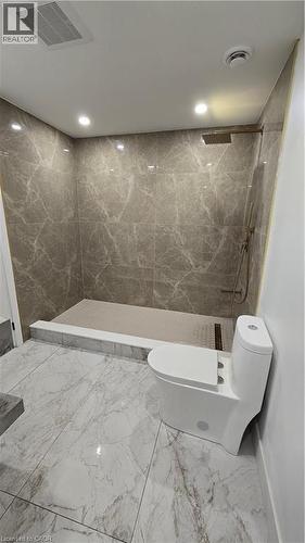 Full bath with a marble finish shower, marble tiled floors, and recessed lighting - 7266 Silver Creek Circle, London, ON - Indoor Photo Showing Bathroom