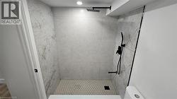 Full bath featuring a stall shower and toilet - 