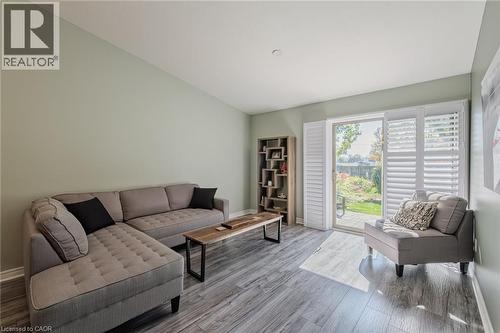 Sliding doors to back yard with california style shutters - 19 Somerset Drive Unit# 16, Port Dover, ON - Indoor Photo Showing Living Room
