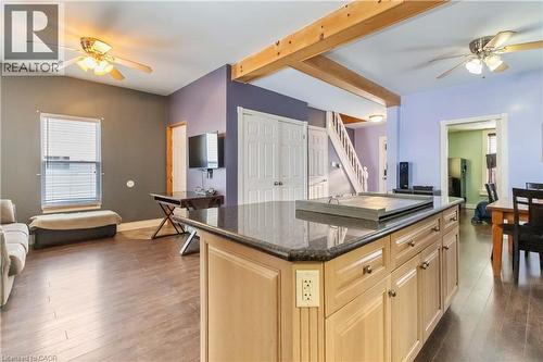 Kitchen featuring a ceiling fan, light brown cabinetry, open floor plan, and a kitchen island - 112 Eagle Avenue, Brantford, ON - Indoor