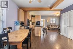 Dining room featuring a ceiling fan, dark wood-type flooring - 