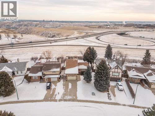 Drone view of house with city & coulee views - 90 Chippewa Crescent W, Lethbridge, AB - Outdoor With View
