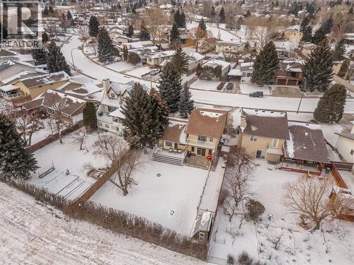 Drone view of house with greenspace behind & parks nearby - 90 Chippewa Crescent W, Lethbridge, AB - Outdoor With View