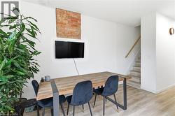 Office space with light wood-type flooring and baseboards - 