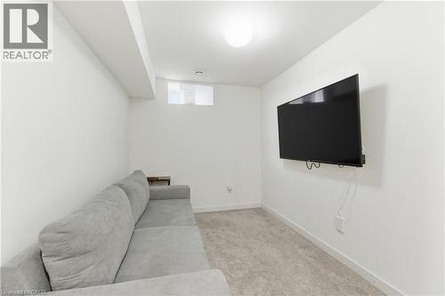 Living room featuring light carpet and baseboards - 40 Fullerton Avenue, Hamilton, ON - Indoor