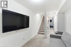 Living area featuring stairway, light colored carpet, and recessed lighting - 