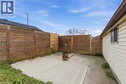 Fenced backyard featuring a patio area - 