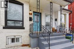 View of exterior entry with brick siding - 