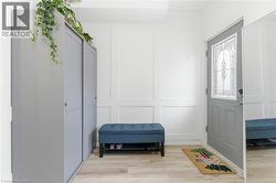 Foyer featuring a decorative wall and wood finished floors - 