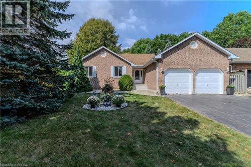 Single story home with a front lawn, driveway, brick siding, and a garage - 5 Newport Lane, Port Dover, ON - Outdoor