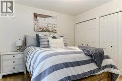 Bedroom with two closets and wood finished floors - 