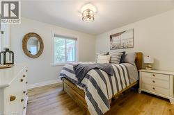 Bedroom featuring light wood finished floors and baseboards - 