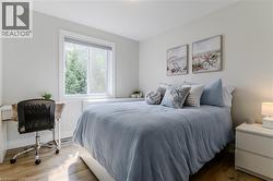 Bedroom featuring wood finished floors and baseboards - 