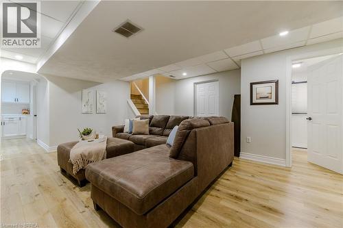Living area with light wood-style flooring, stairs, recessed lighting, a drop ceiling, and arched walkways - 5 Newport Lane, Port Dover, ON - Indoor
