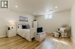 Bedroom with light wood finished floors and recessed lighting - 