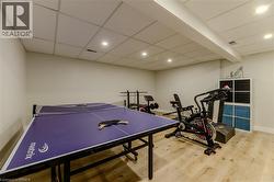 Playroom featuring recessed lighting, light wood-style flooring, and a paneled ceiling - 