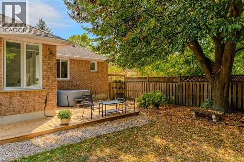 Fenced backyard featuring a hot tub and a deck - 5 Newport Lane, Port Dover, ON - Outdoor With Deck Patio Veranda