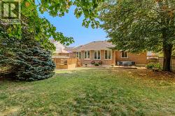 Back of property featuring a patio area, brick siding, and a wooden deck - 