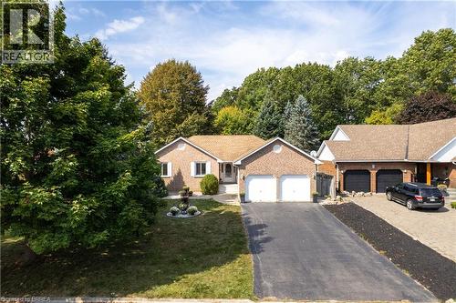 Single story home with driveway, brick siding, and a garage - 5 Newport Lane, Port Dover, ON - Outdoor With Facade