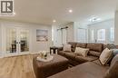 Living area with a barn door, wood finished floors, french doors, and recessed lighting - 5 Newport Lane, Port Dover, ON  - Indoor Photo Showing Living Room 