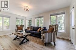 Living room with light wood-style flooring and baseboards - 