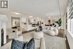 Living area featuring wood finished floors and a fireplace - 