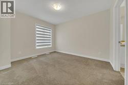Empty room with light colored carpet and a textured ceiling - 