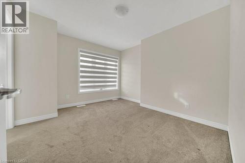 Spare room featuring light carpet and baseboards - 285 Broadacre Drive, Kitchener, ON - Indoor Photo Showing Other Room