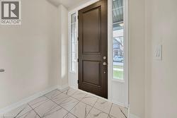 Entryway with light marble finish flooring and plenty of natural light - 
