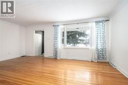 Spare room featuring light wood-style floors and baseboards - 