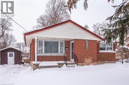 Bungalow-style house featuring a storage shed and brick siding - 120 Fourth Avenue, Kitchener, ON - Outdoor