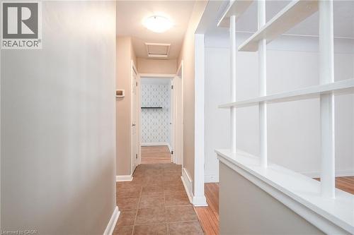 Hall with attic access, wallpapered walls, and light tile patterned floors - 120 Fourth Avenue, Kitchener, ON - Indoor Photo Showing Other Room