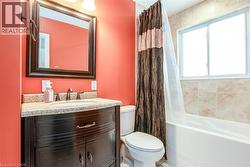 Bathroom featuring vanity and shower / tub combo with curtain - 