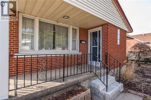 Entrance to property featuring brick siding and covered porch - 120 Fourth Avenue, Kitchener, ON - Outdoor With Deck Patio Veranda