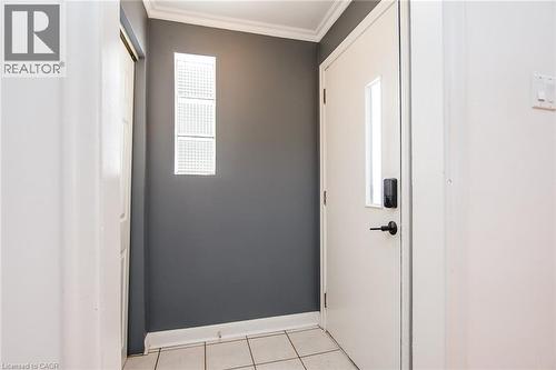 Doorway to outside with crown molding and tile patterned floors - 120 Fourth Avenue, Kitchener, ON - Indoor Photo Showing Other Room