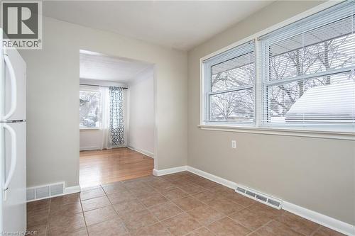 Spare room featuring plenty of natural light and light tile patterned floors - 120 Fourth Avenue, Kitchener, ON - Indoor Photo Showing Other Room