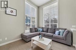 Sun-filled living room with large windows - 