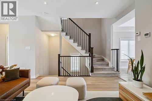 Living area featuring light wood-style floors, stairway, and recessed lighting - 2220 Queensway Drive Unit# 15, Burlington, ON - Indoor