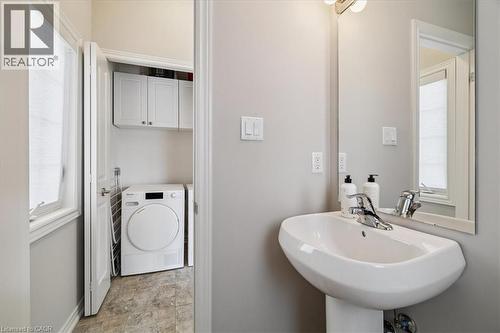 Bathroom featuring washer / clothes dryer, plenty of natural light, and stone finish flooring - 2220 Queensway Drive Unit# 15, Burlington, ON - Indoor