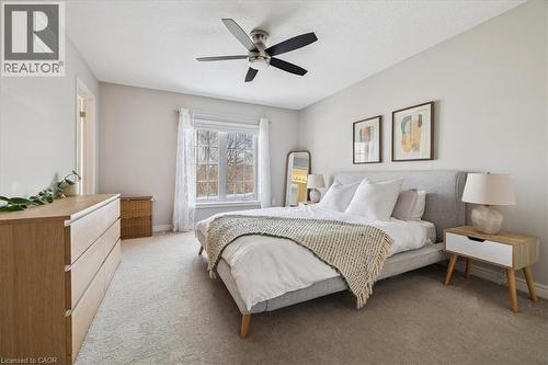 Bedroom featuring ceiling fan, light colored carpet, and a textured ceiling - 2220 Queensway Drive Unit# 15, Burlington, ON - Indoor Photo Showing Bedroom