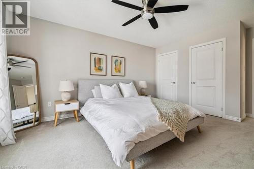 Carpeted bedroom featuring a ceiling fan and baseboards - 2220 Queensway Drive Unit# 15, Burlington, ON - Indoor Photo Showing Bedroom