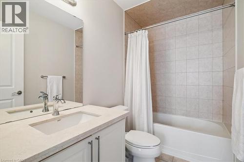 Bathroom featuring vanity, shower / bathtub combination with curtain, and light tile patterned floors - 2220 Queensway Drive Unit# 15, Burlington, ON - Indoor Photo Showing Bathroom