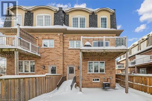 Snow covered property featuring a balcony, brick siding, and stucco siding - 2220 Queensway Drive Unit# 15, Burlington, ON - Outdoor With Balcony