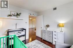 Bedroom featuring dark wood-type flooring - 