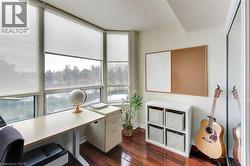 Office featuring dark wood finished floors and baseboards - 