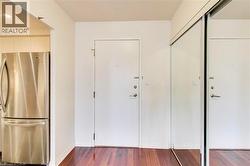 Foyer entrance with dark wood-style floors and baseboards - 